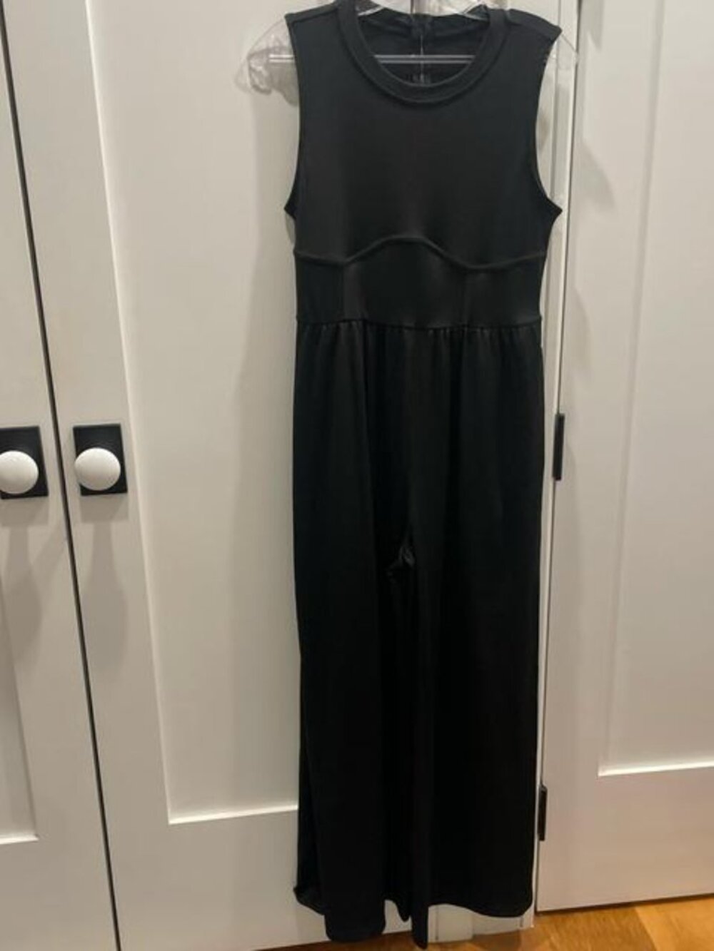 Black jumpsuit with a structured top and flowy skirt